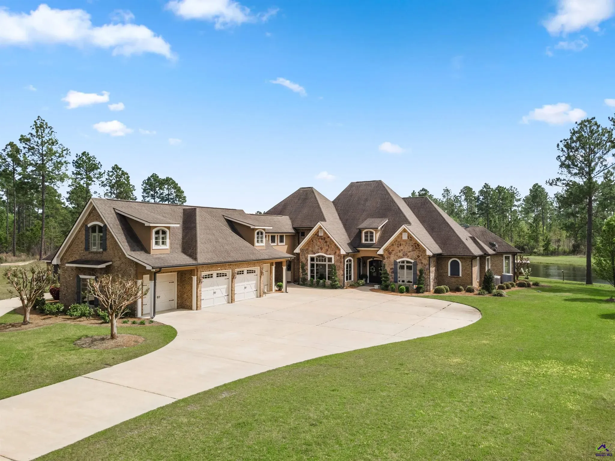 A custom stone and brick home with a three-car garage